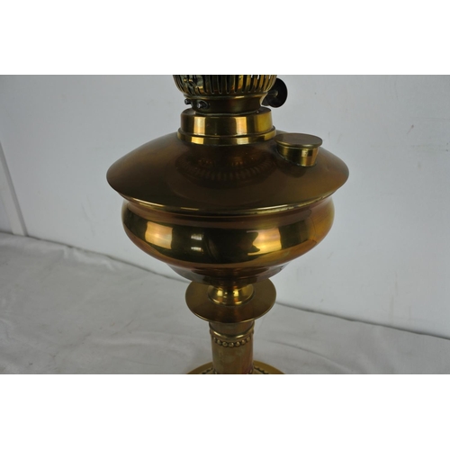 517 - An antique brass based oil lamp and etched glass shade.