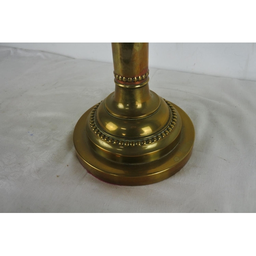 517 - An antique brass based oil lamp and etched glass shade.