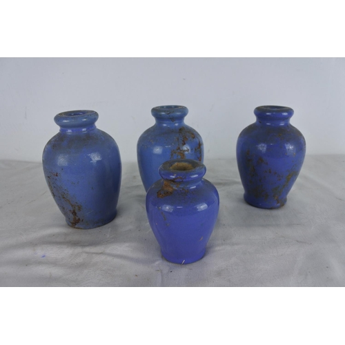 521 - A set of four blue glaze stoneware bottles.