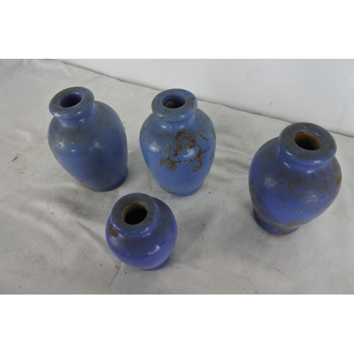 521 - A set of four blue glaze stoneware bottles.