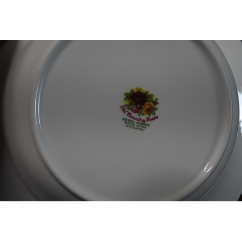 527 - A large collection of Royal Albert Old Country Rose to include dinner plates, soup bowls and more.