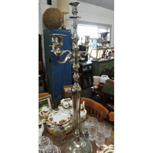 532 - A large silver metal four branch candelabra, measuring 104cm tall.