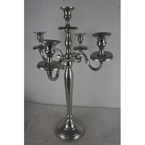 548 - A silver metal four branch candelabra, measuring 60cm tall.