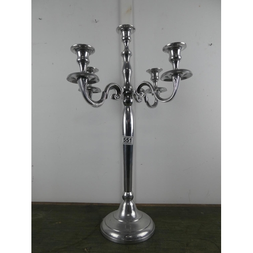 551 - A silver metal four branch candelabra, measuring 60cm tall.