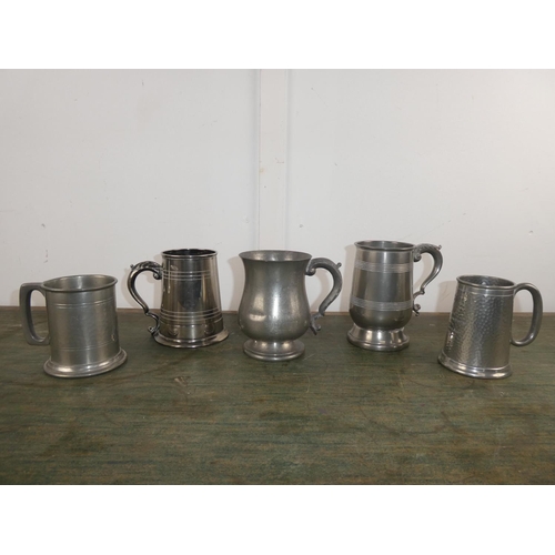 552 - A job lot of pewter tankards and more.