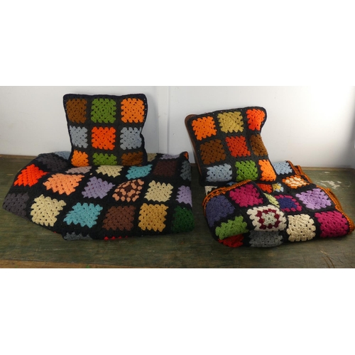 559 - A large handcrafted throw and matching cushions.