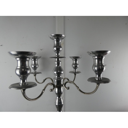 571 - A tall silver metal four branch candelabra, measuring 78cm tall.