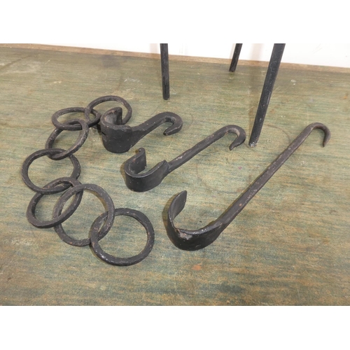 585 - A collection of wrought iron ware to include pot stand, hooks etc.