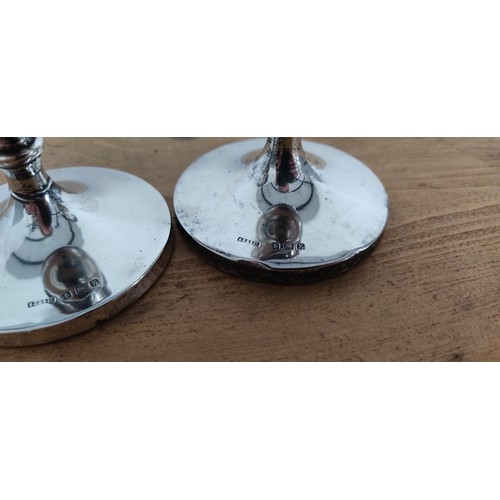 567 - A pair of Sterling Silver candlesticks stamped for Birmingham - 'S.B & S. Ld'.