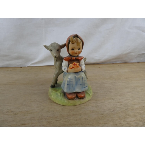 103 - A Goebel Hummel figurine, 'Girl with lamb'.