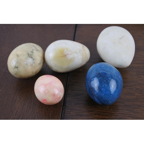 32 - A collection of five marble eggs.