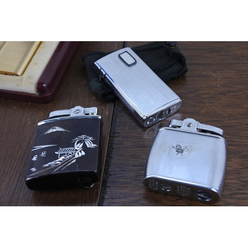 53 - A vintage Sarome cased lighter and three others.