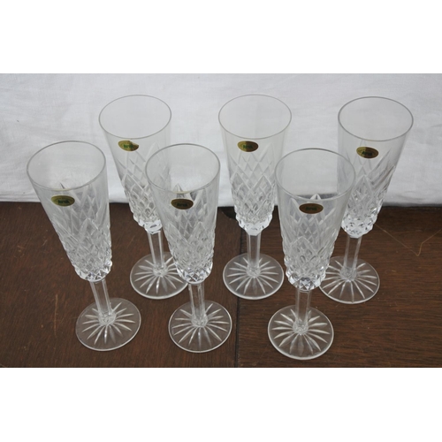 77 - A set of six Tyrone crystal champagne flutes.