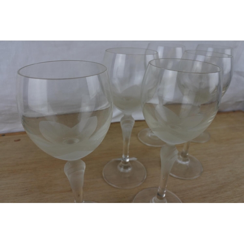 87 - An unusual set of six etched wine glasses.