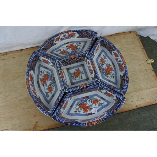 92 - A set of five oriental style serving dishes on a swivel stand.