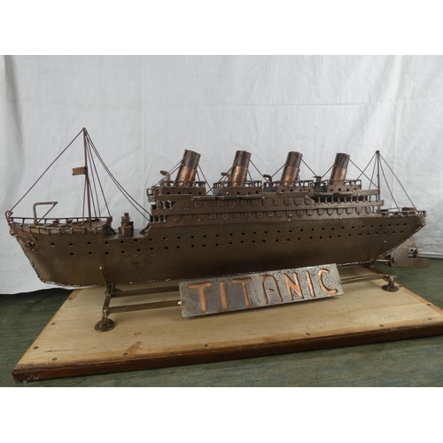 527 - A large metal model of the Titanic on stand. (Measuring 82cm).