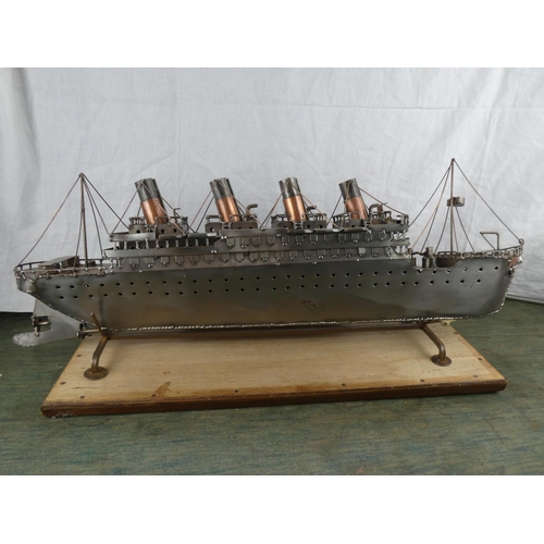 527 - A large metal model of the Titanic on stand. (Measuring 82cm).