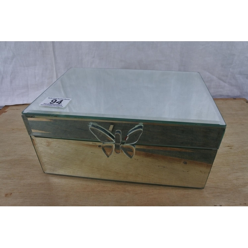 94 - A mirrored jewellery box with contents.