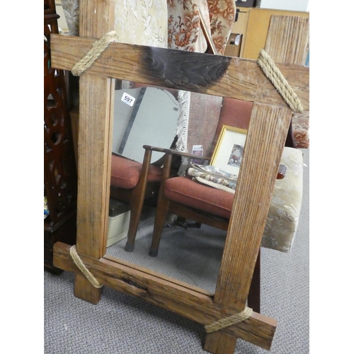 597 - A rustic wood framed mirror.