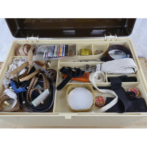 604 - A vintage sewing box with contents.