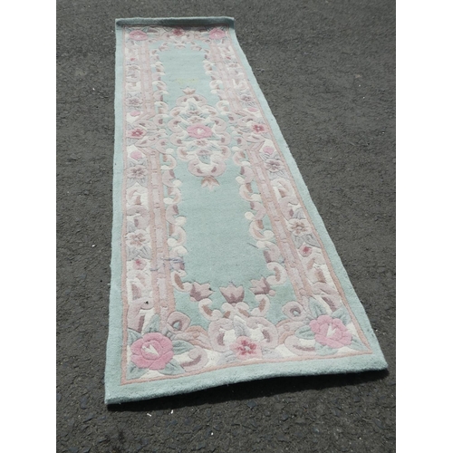 617 - A decorative hall runner rug. (Measuring 210cm).