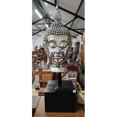 579 - A stunning extra large silver effect Buddha head on stand, measuring 98cm tall.