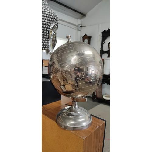 580 - A large silver effect globe on stand, measuring 52cm tall.