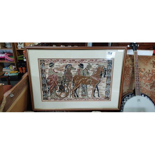 584 - A stunning framed needlepoint tapestry of a Roman Chariot scene, measuring 76x55cm.