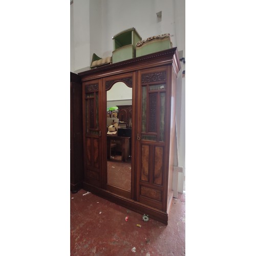 995 - A stunning antique triple wardrobe with mirror door, in need of some restoration.