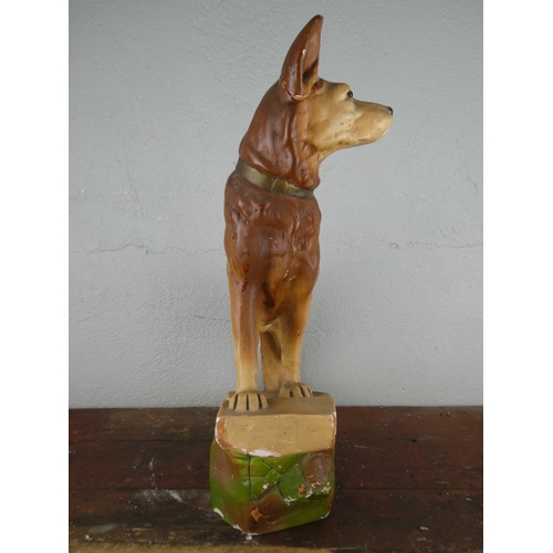 115 - A large chalkware figurine of an Alsatian dog, measuring 45cm tall.
