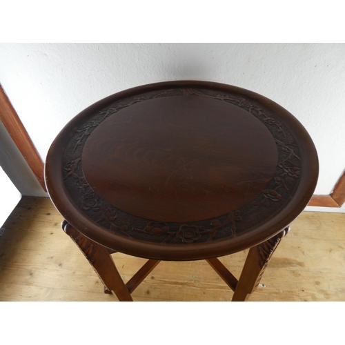 127 - A carved mahogany butlers tray and folding stand.