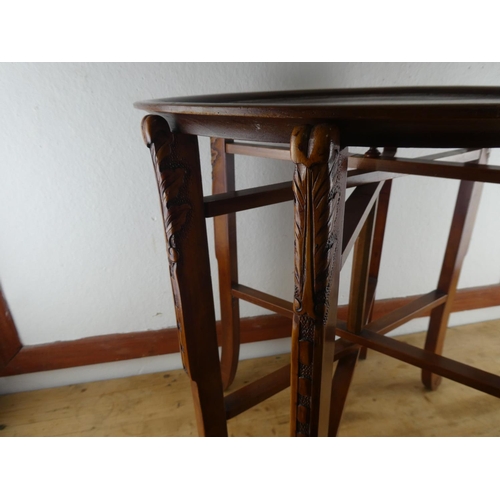 127 - A carved mahogany butlers tray and folding stand.