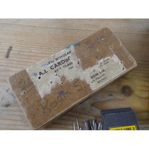 152 - An assortment of vintage thimbles and a vintage cardboard box containing sewing needles and more.