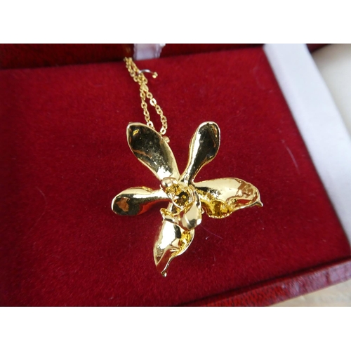 165 - A boxed L'Orient of Singapore gold plated Lotus flower necklace.