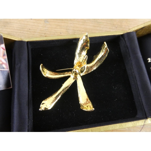 166 - A boxed 24ct gold plated orchid brooch.