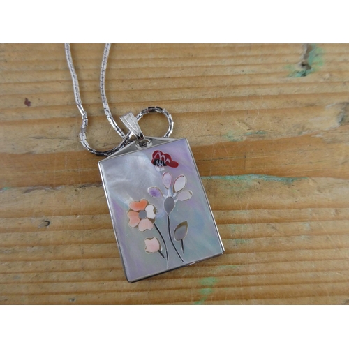 169 - A decorative mother of pearl necklace and chain.
