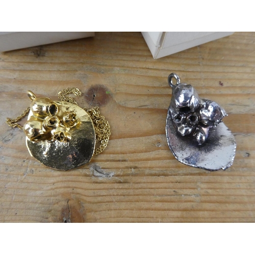 170 - A boxed Triton pendant and necklace and another pendant.