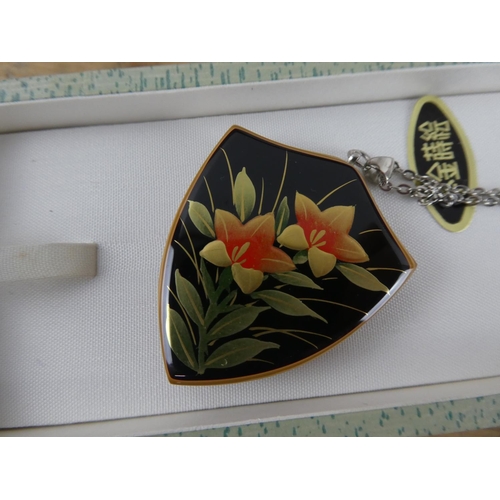 174 - A boxed hand painted pendant and necklace.