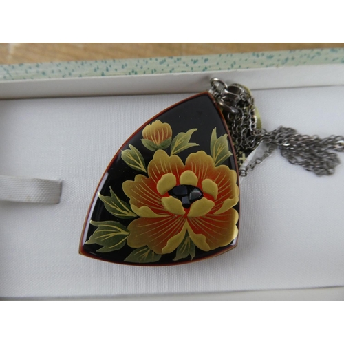 174 - A boxed hand painted pendant and necklace.