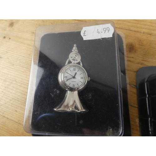177 - A lot of four boxed miniature clocks.