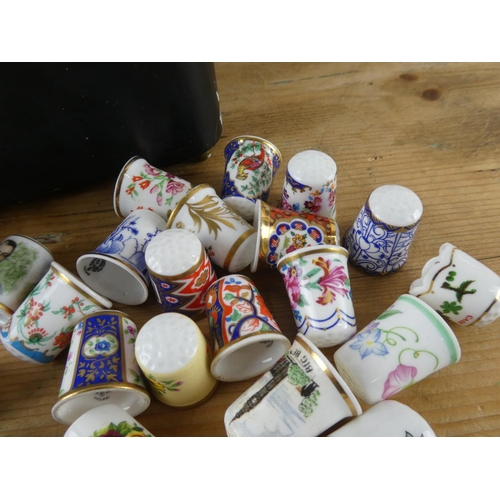 178 - A vintage lidded jewellery box and a large collection of thimbles.