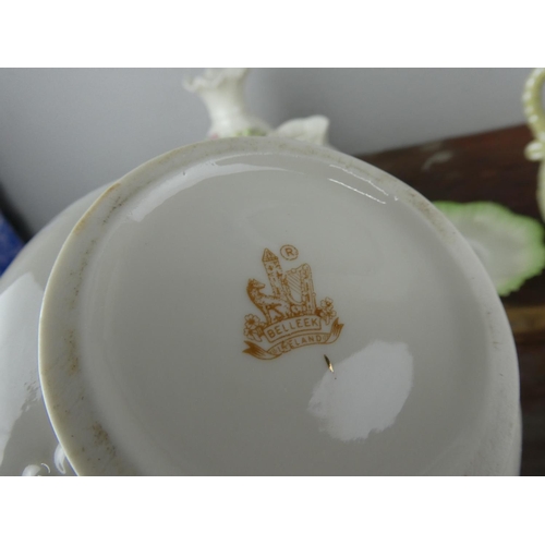 73 - A large collection of Belleek pottery.