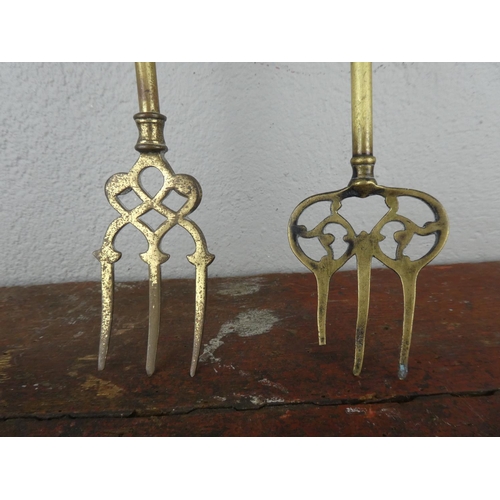 76 - Two vintage brass toasting forks.