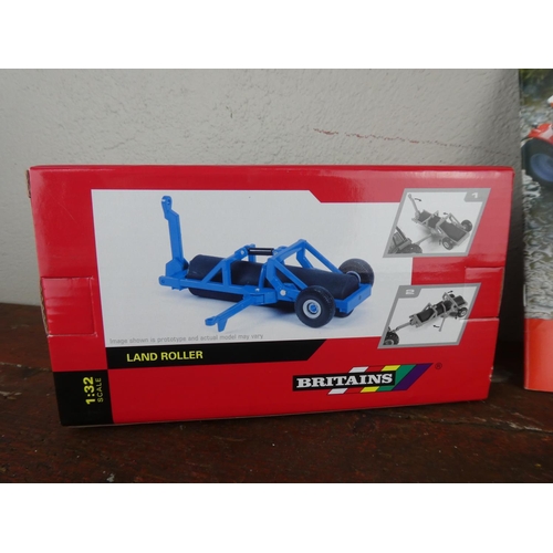78 - A boxed Britains land roller and magazine.