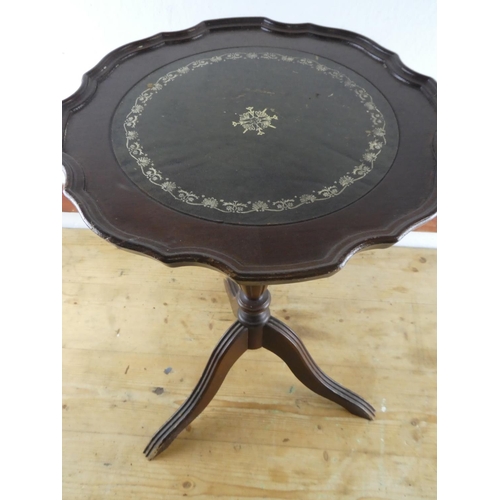 262 - A leather topped wine table.