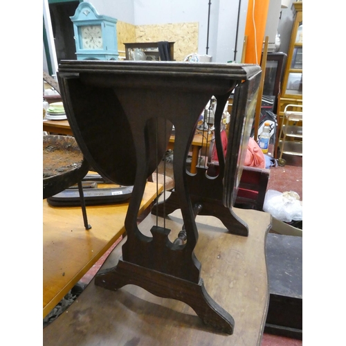 274 - A small drop leaf table with leather top.
