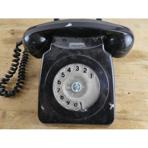 285 - A vintage black rotary telephone.