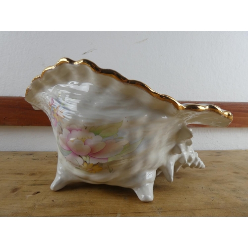 297 - A large ceramic shell plant pot with floral design.