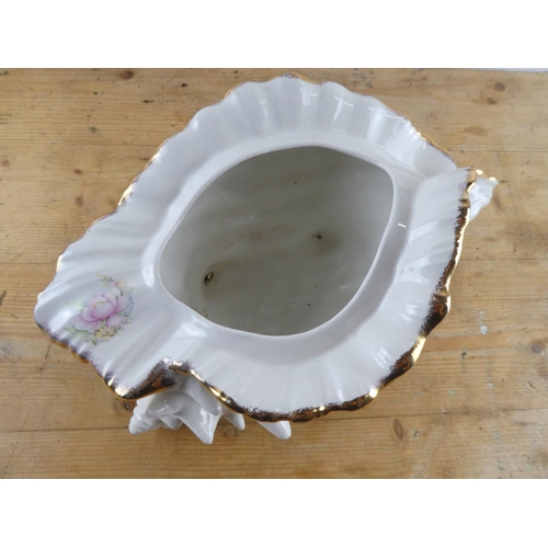 297 - A large ceramic shell plant pot with floral design.