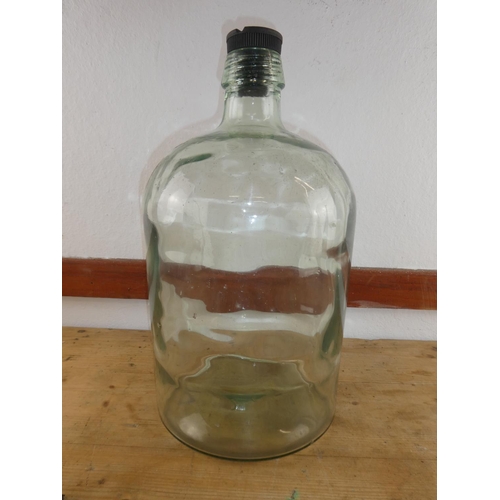 307 - A large clear glass lidded bottle, measuring 44cm tall.